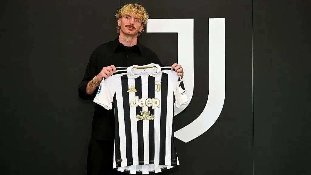 Player holding Juventus jersey during announcement event