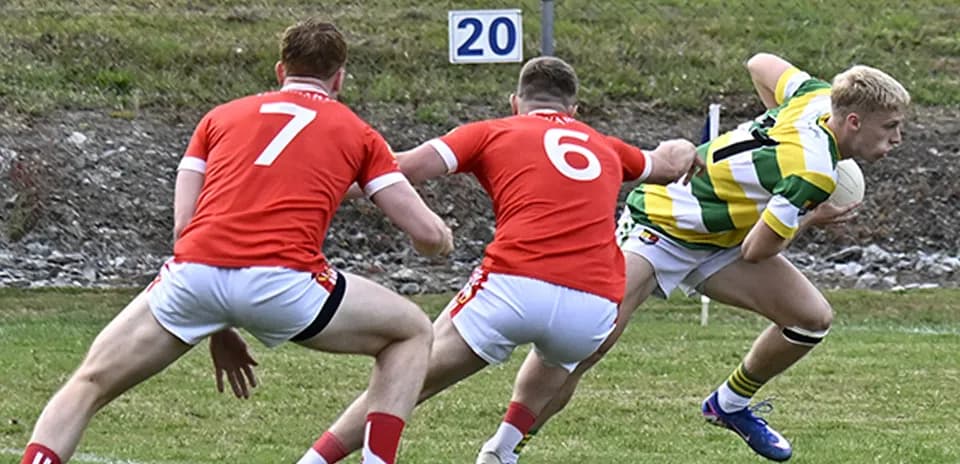 Player in green jersey evading two red defenders