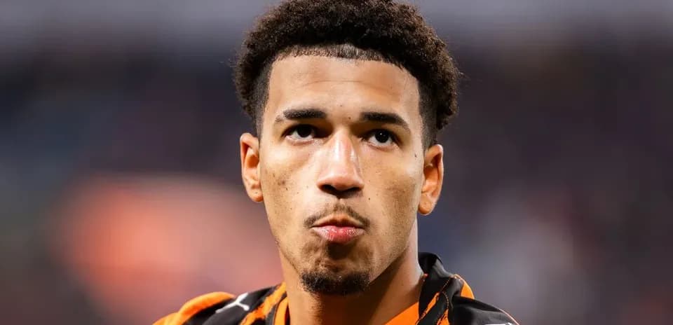 Player in orange kit during match close-up