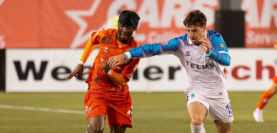 Players competing for the ball during match