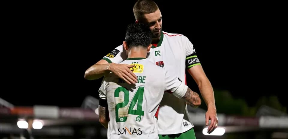 Two players embracing on the field after match
