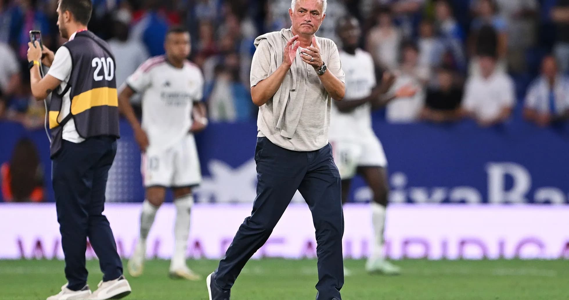 Coach clapping on the sideline during match