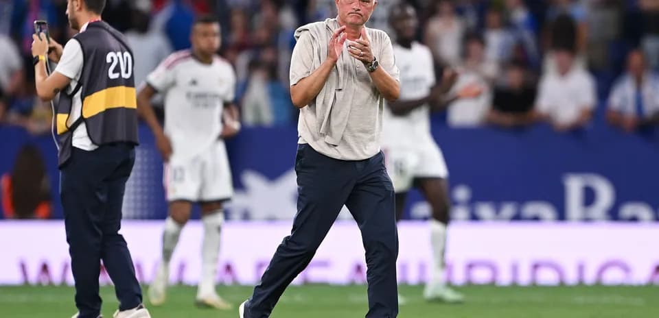 Coach clapping on the sideline during match