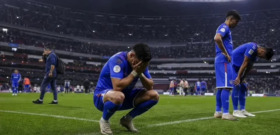 Cruz Azul players react after match loss on field