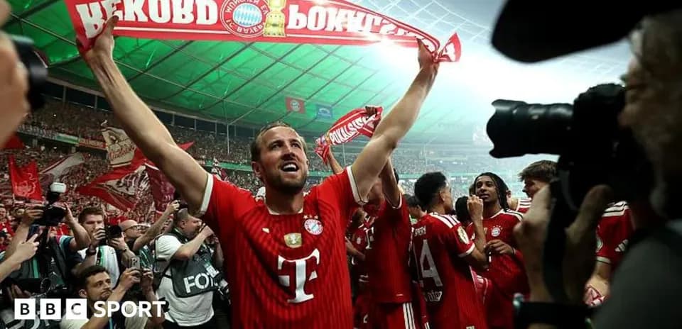Player celebrating with scarf in crowded stadium