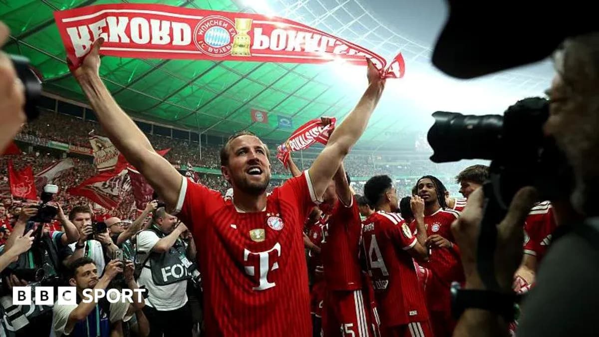Player celebrating with scarf in crowded stadium
