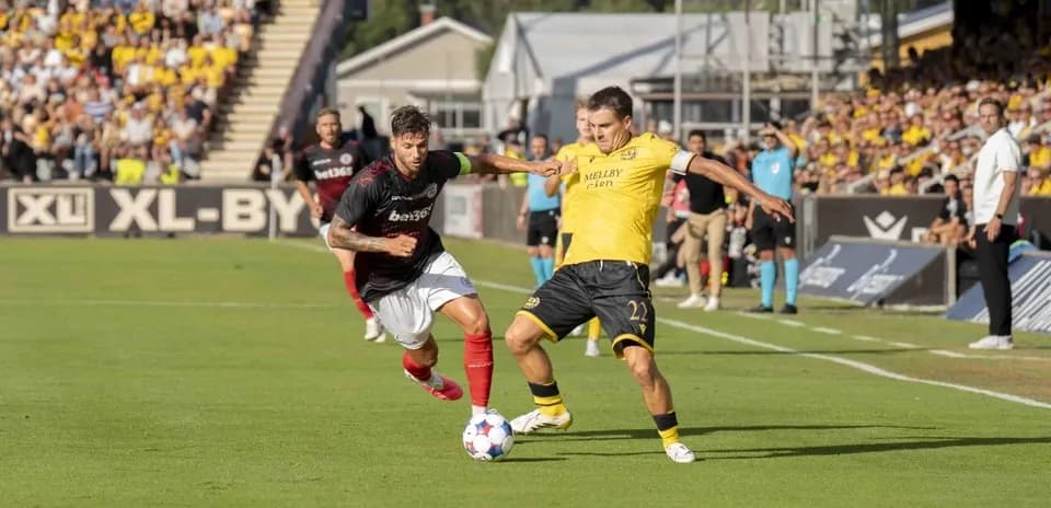Players competing for the ball during football match