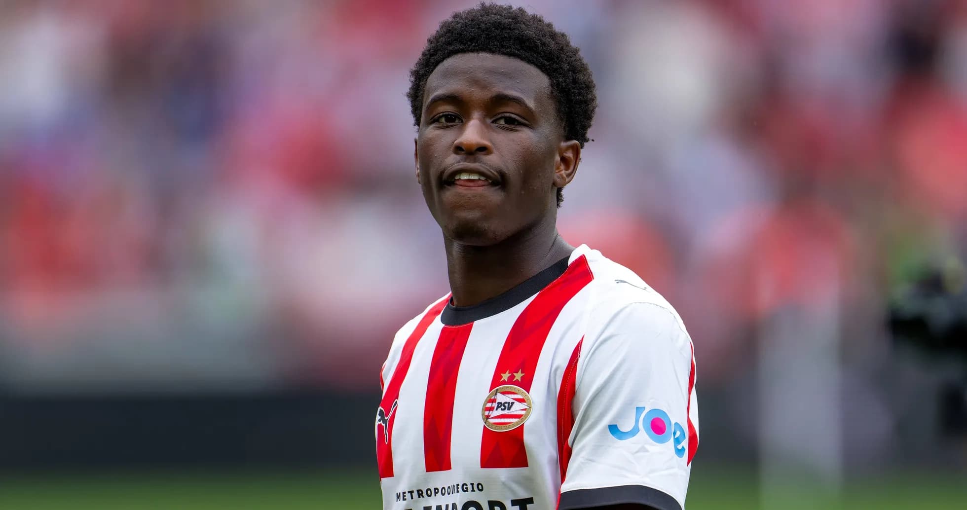 Player in PSV Eindhoven kit at stadium