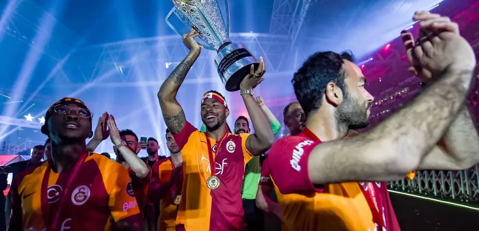 Player celebrating with trophy at victory parade