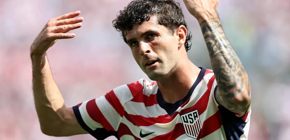 Player gesturing during match wearing USA jersey