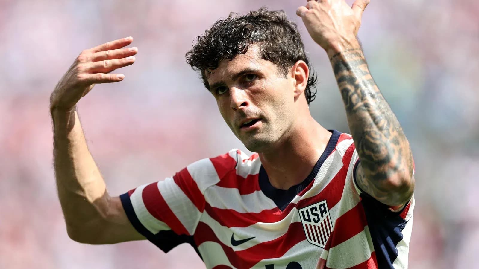 Player gesturing during match wearing USA jersey