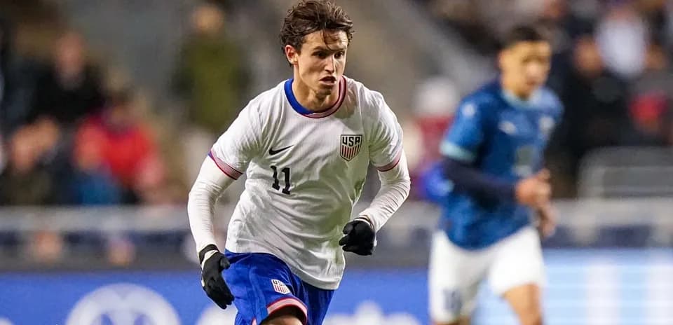 Player in USA jersey running during soccer match