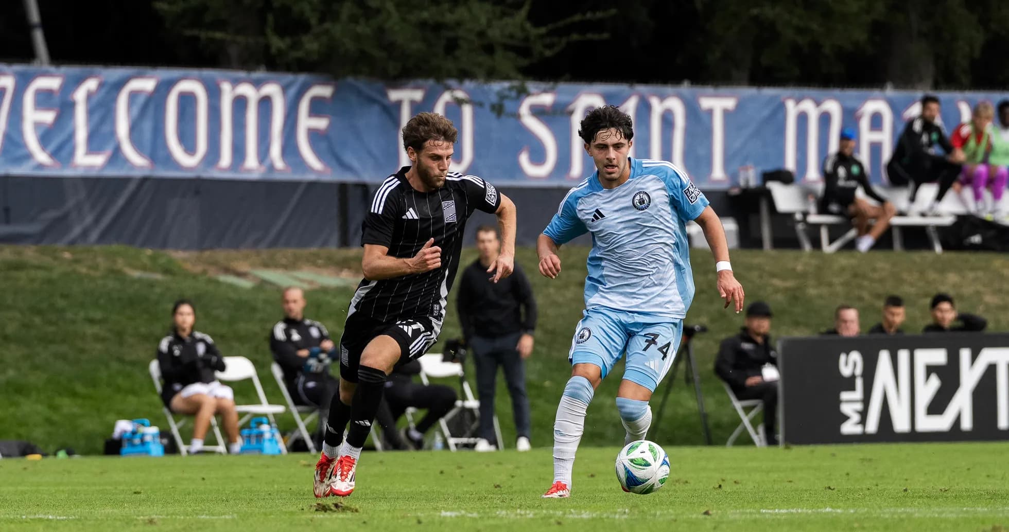 Players competing for the ball in MLS Next Pro match