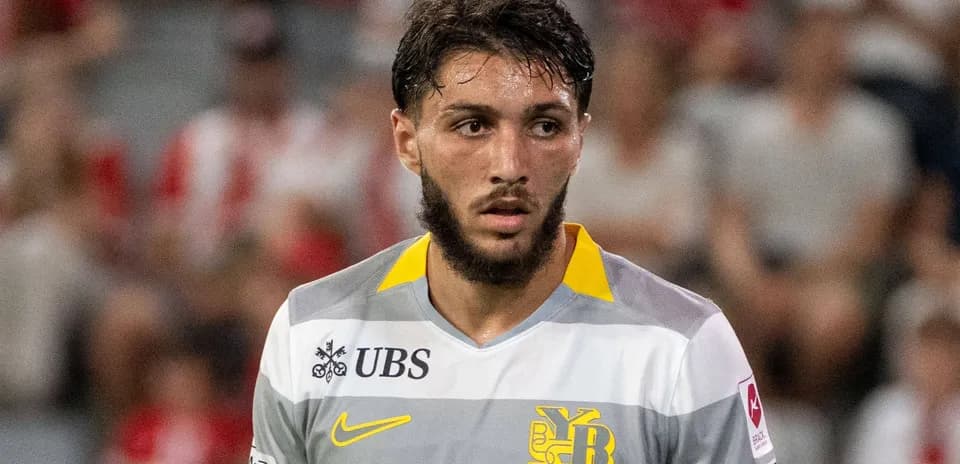 Player wearing gray and yellow jersey during match