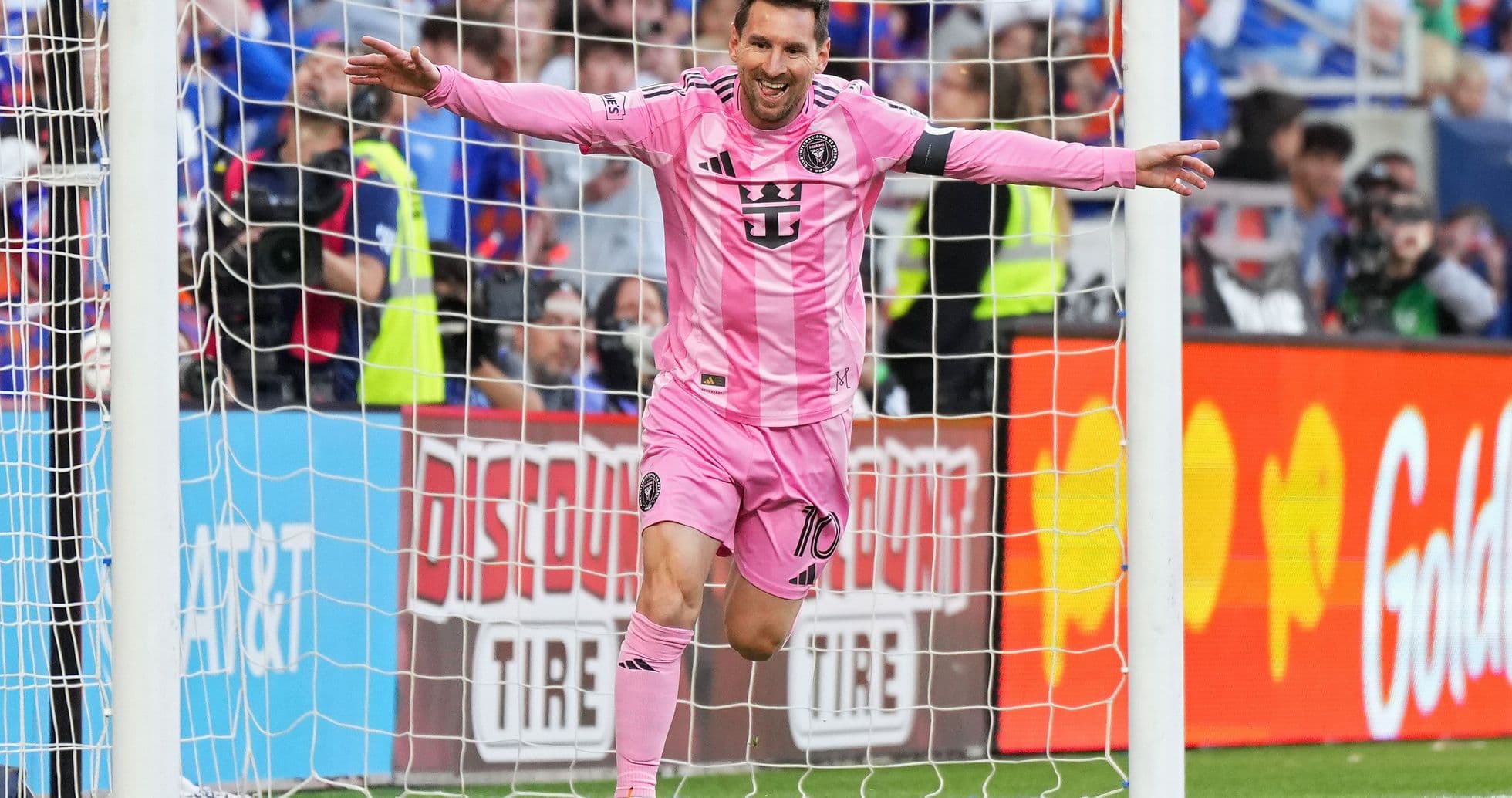 Player celebrating a goal in pink jersey