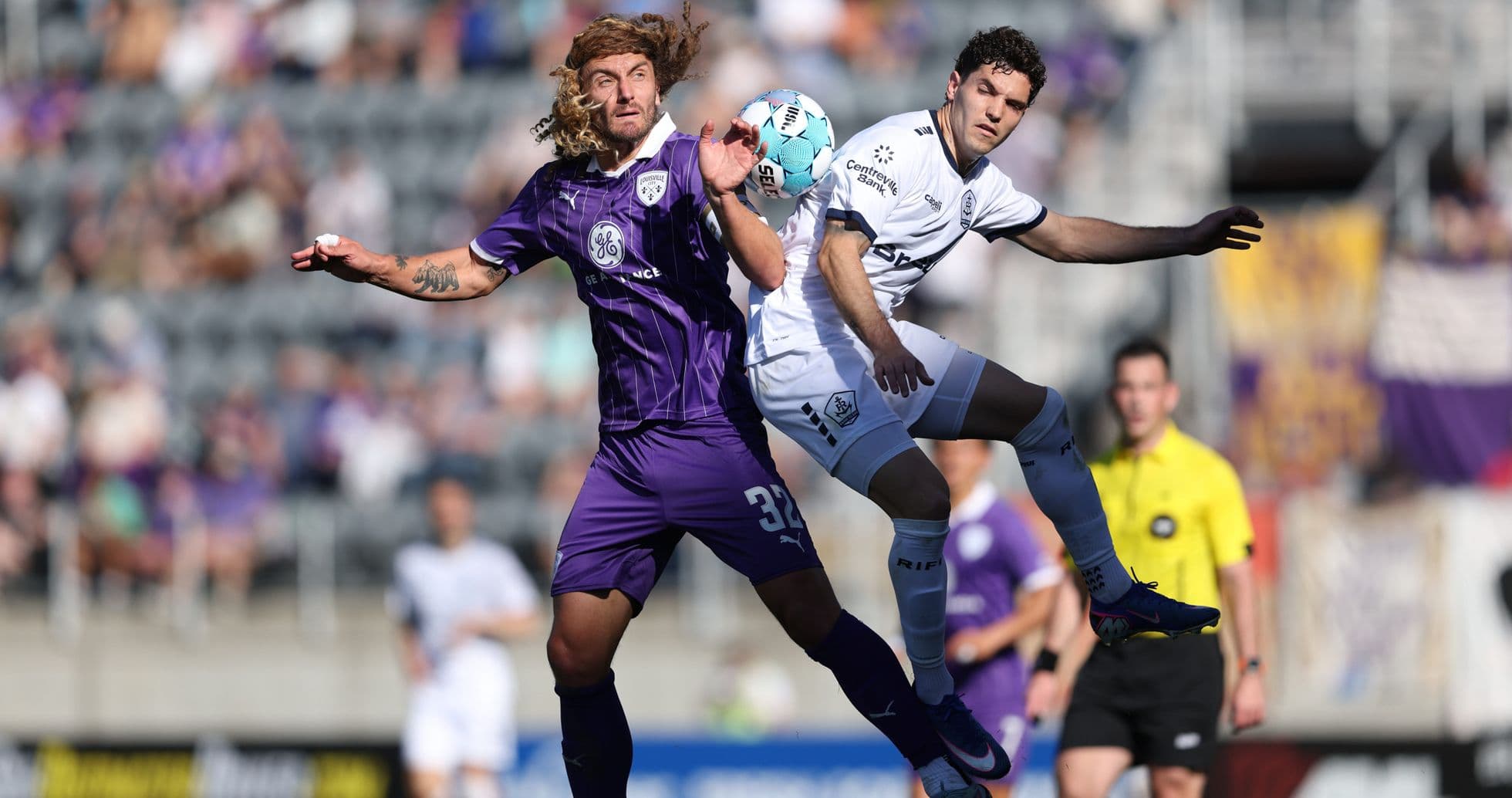 Players contesting for the ball during match