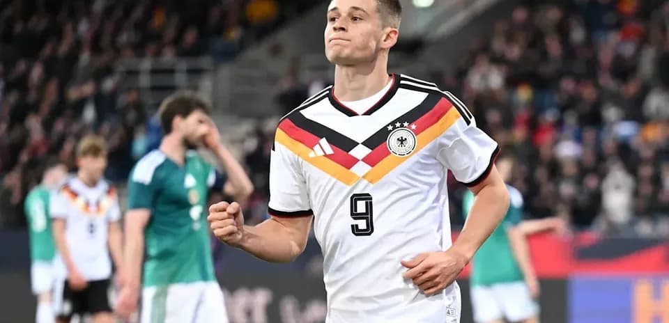 Player celebrating during a match wearing Germany jersey