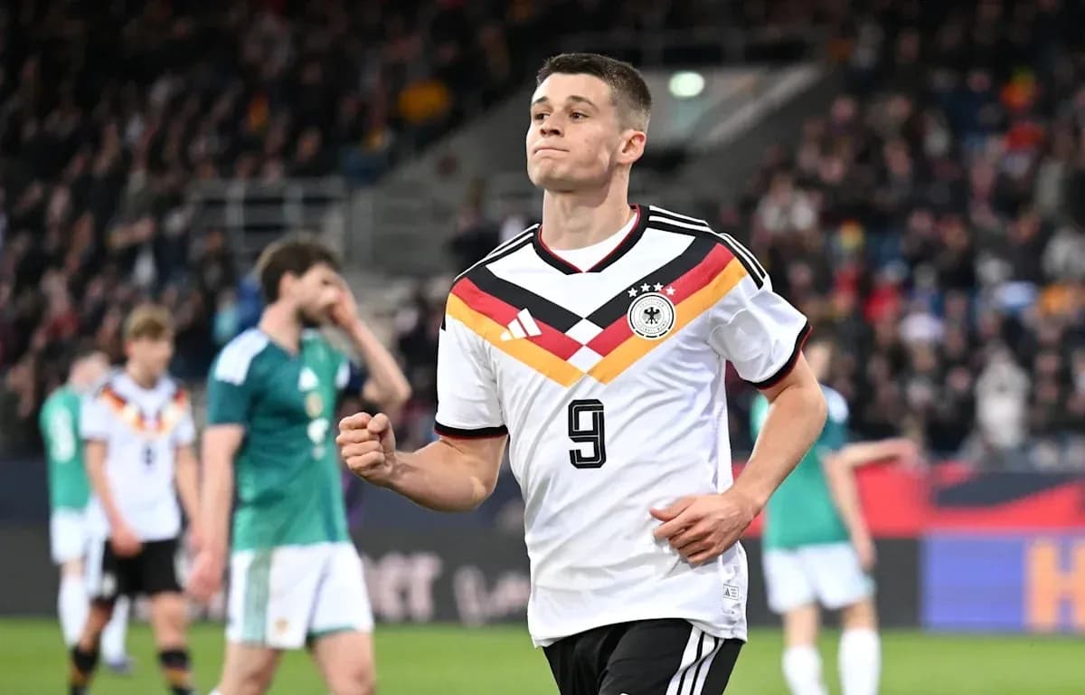 Player celebrating during a match wearing Germany jersey