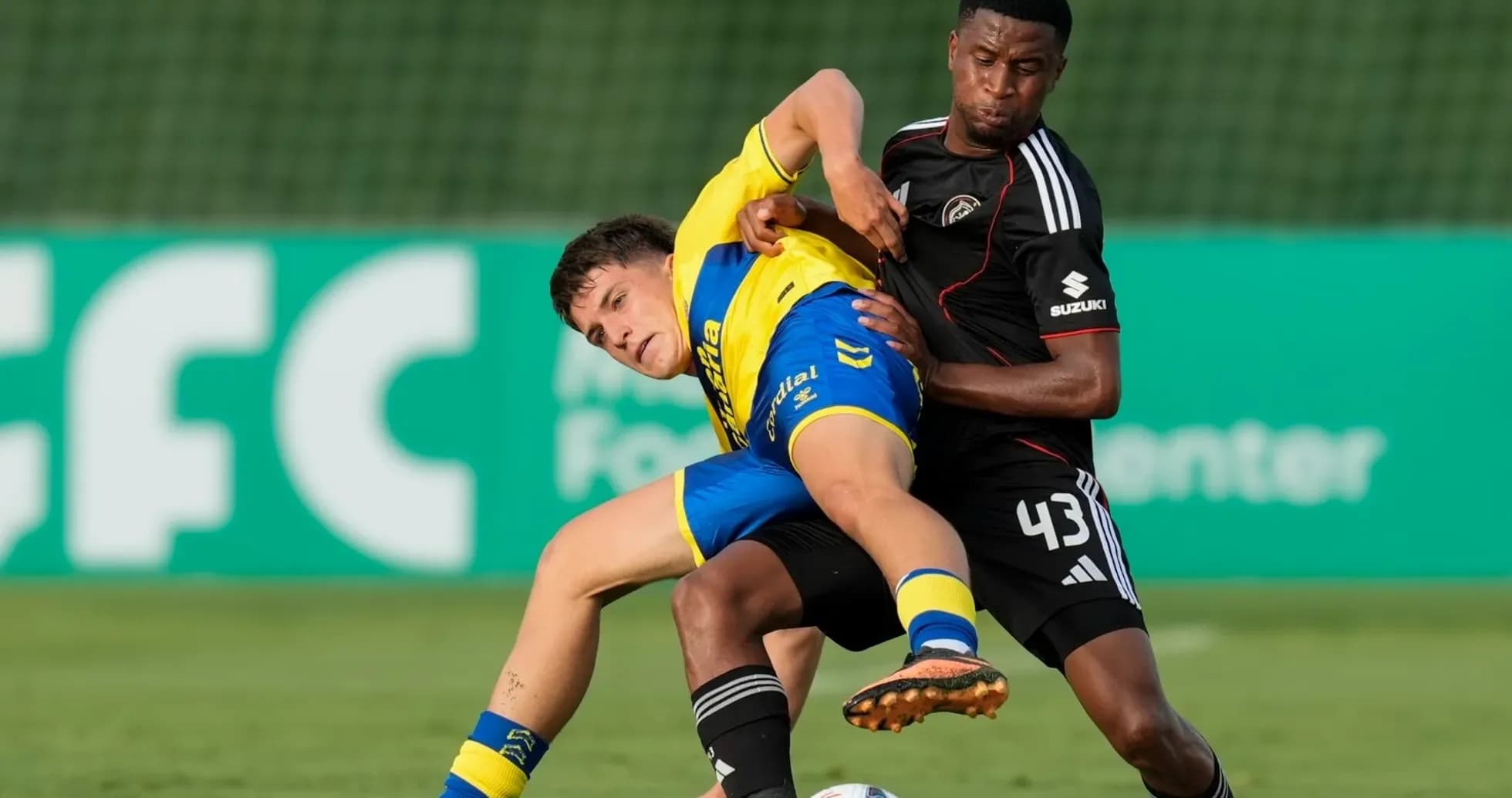 Two players competing for the ball on the field