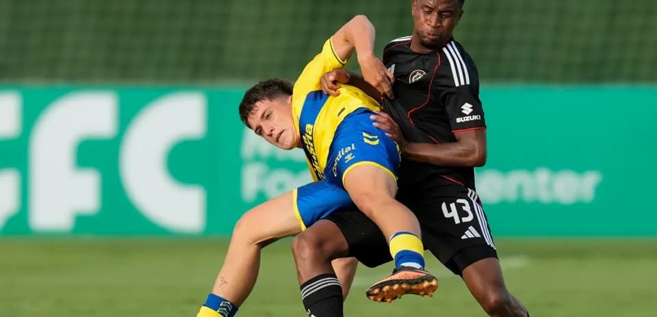 Two players competing for the ball on the field
