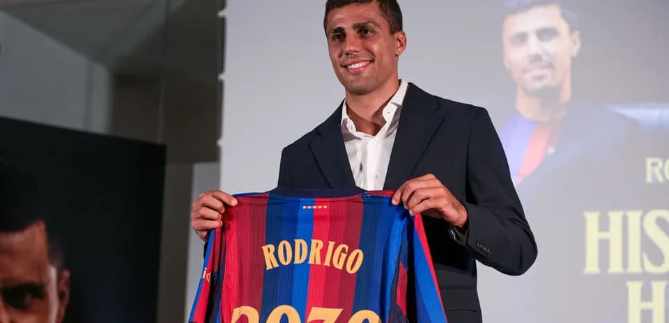 Player presenting Barcelona jersey with 'Rodrigo 2030'