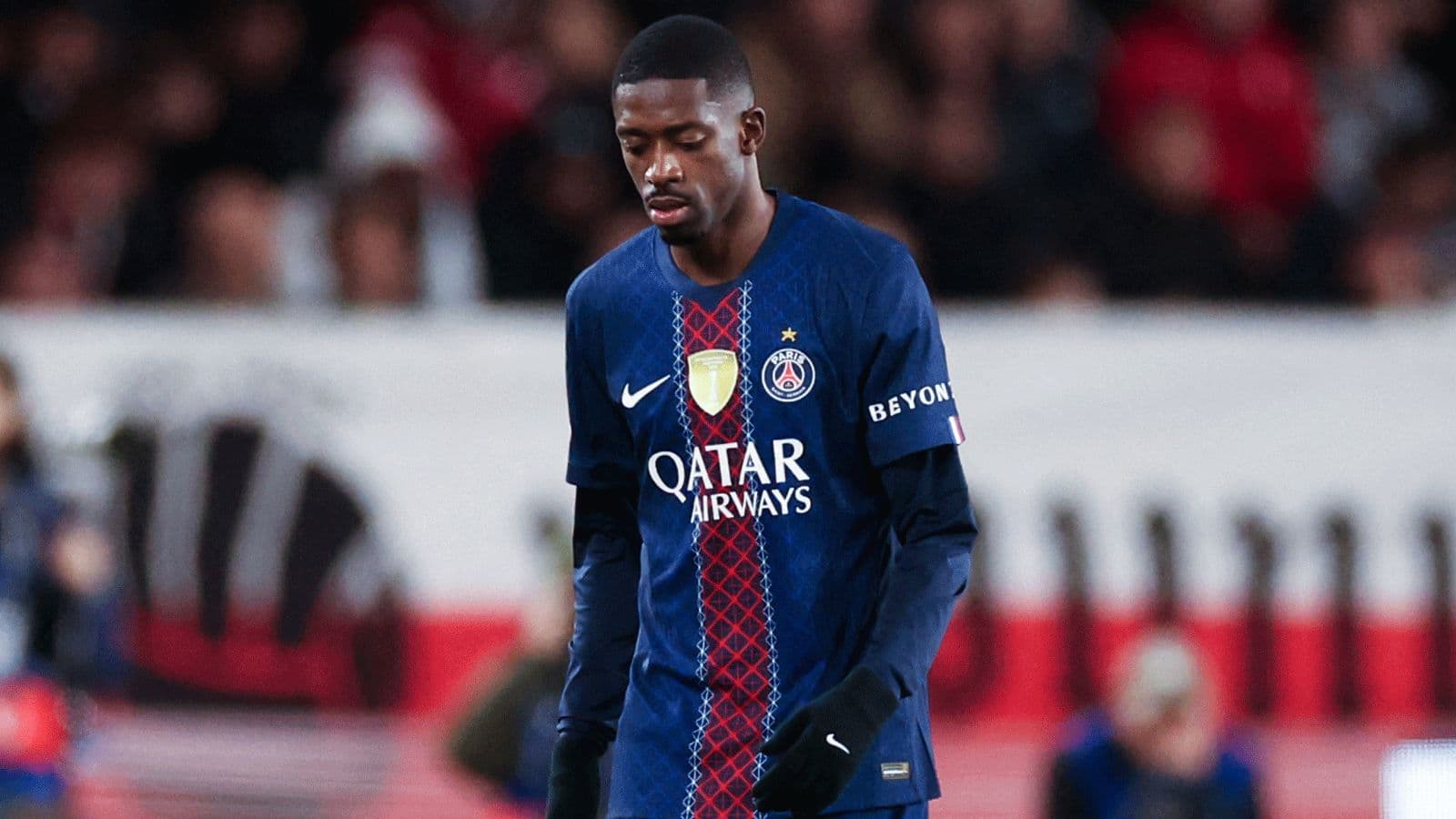 Player in PSG jersey walking with head down