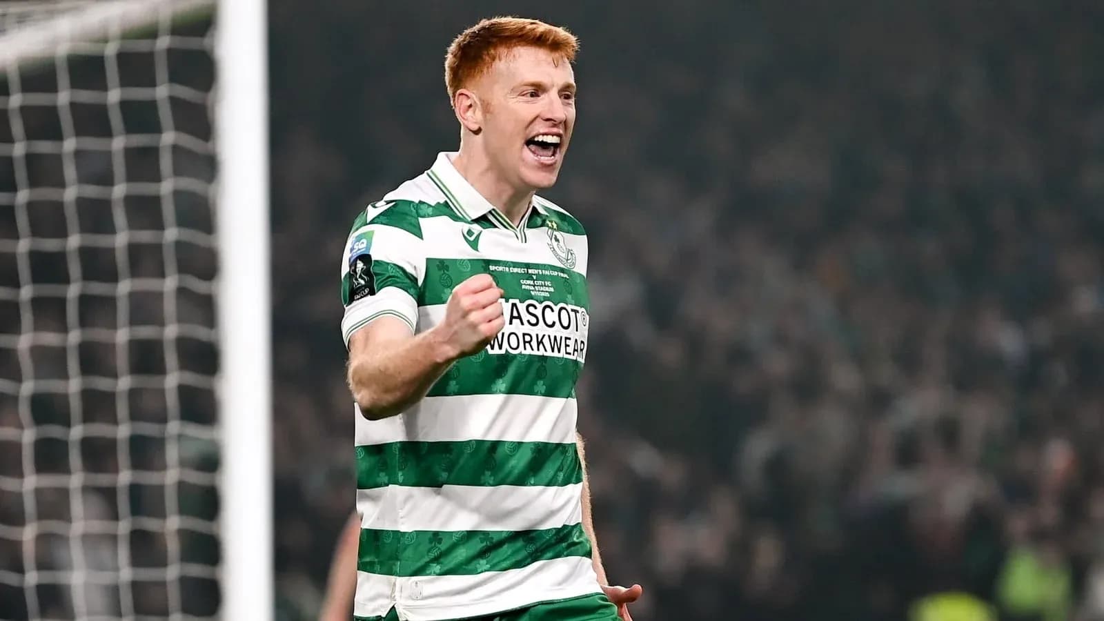 Player celebrating in green and white striped jersey