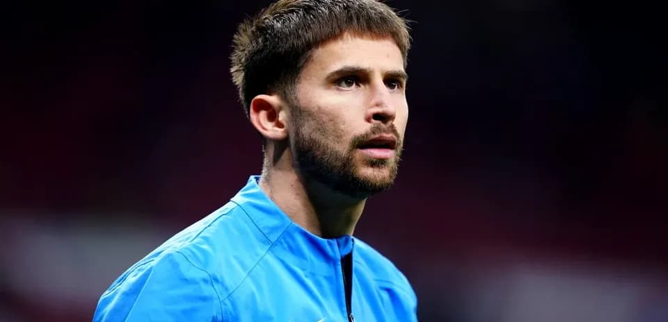 Player in blue kit during pre-match warm-up