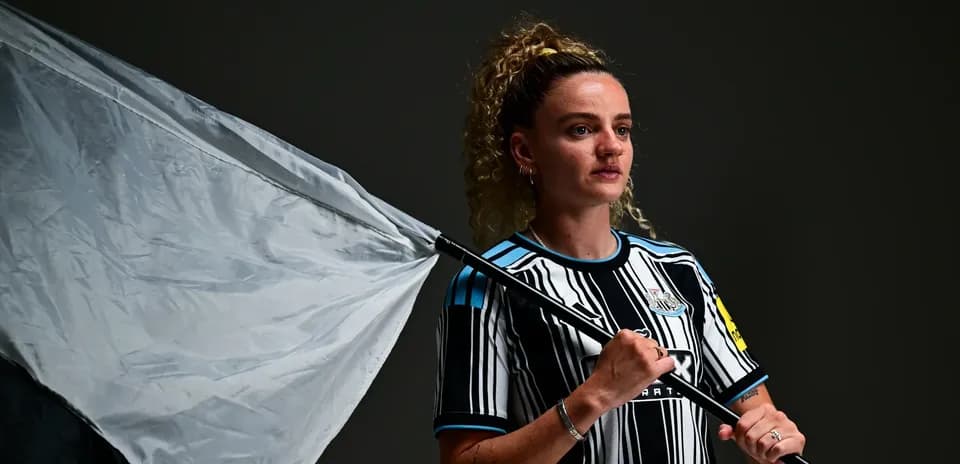 Player holding a flag in Newcastle kit