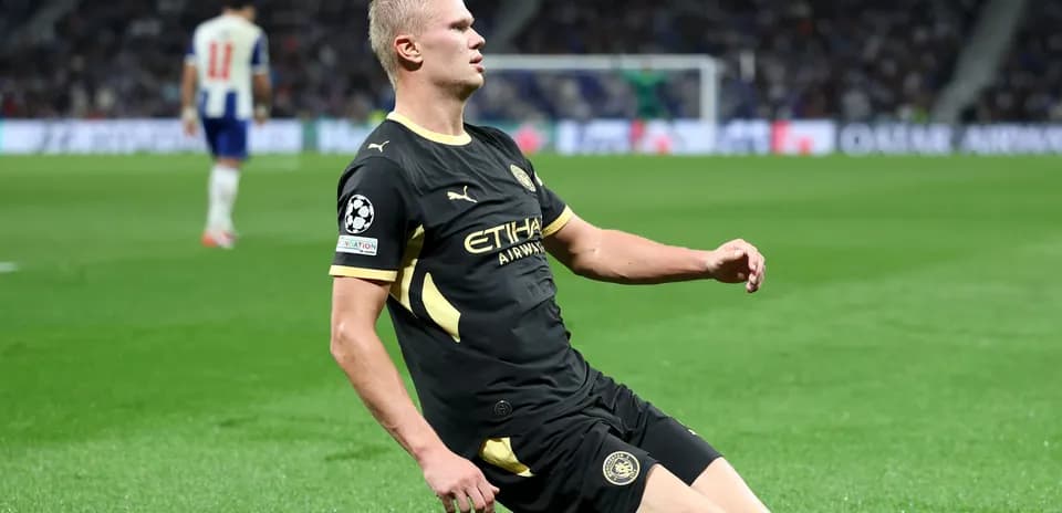 Player sliding on field during Champions League match