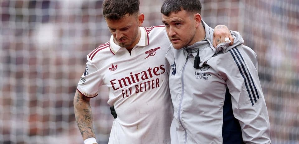 Player receiving assistance from medical staff on field