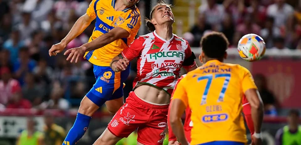 Players contesting for the ball during Liga MX match