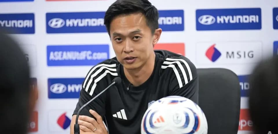 Manager speaking at press conference with football