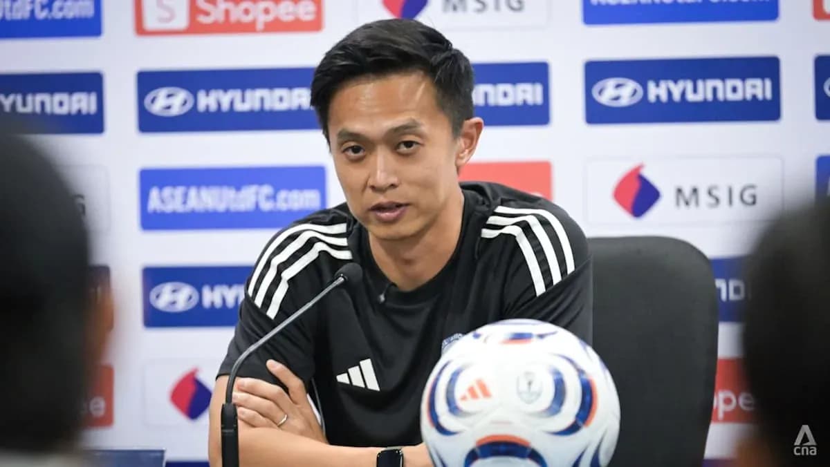 Manager speaking at press conference with football