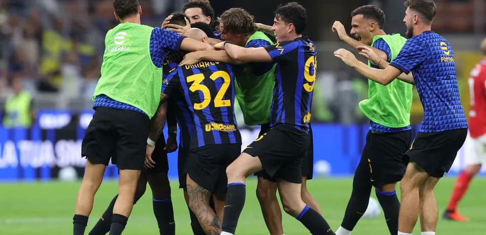 Players celebrating a goal on the field