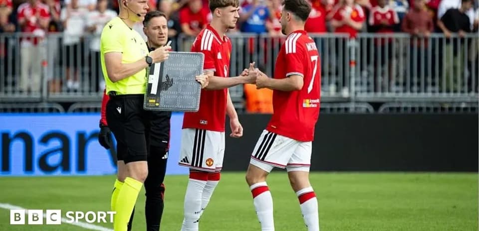 Players exchanging handshakes during substitution