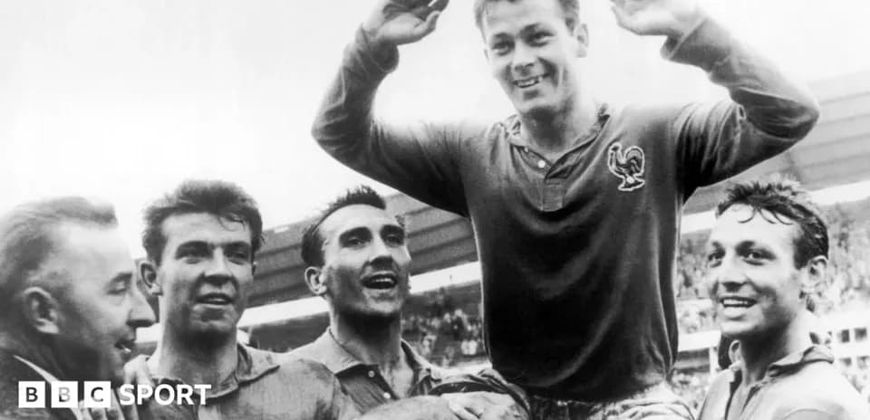 Players celebrating a victory with one player lifted