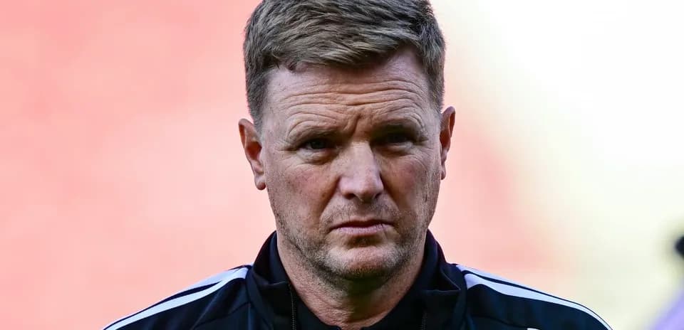 Manager in black training attire on field