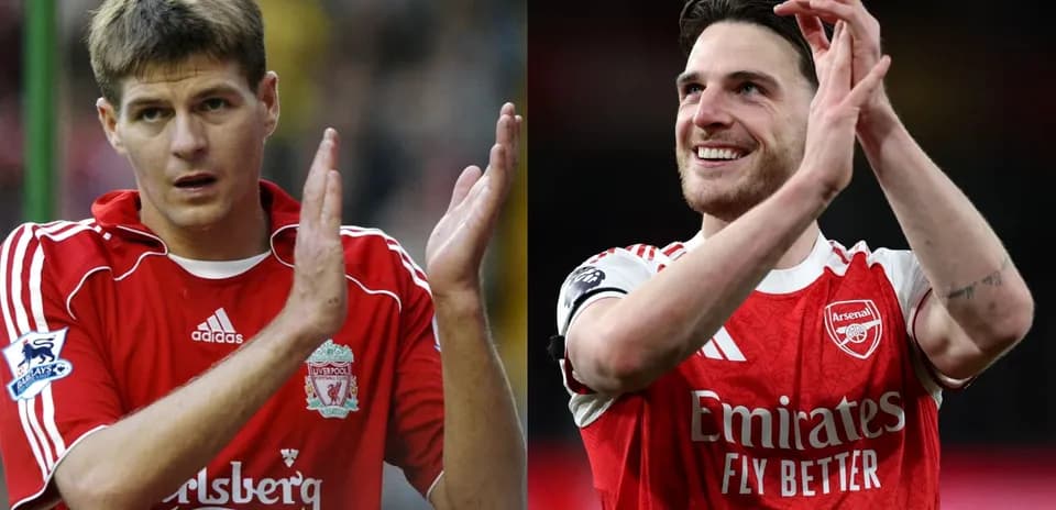 Two football players applauding fans after a match