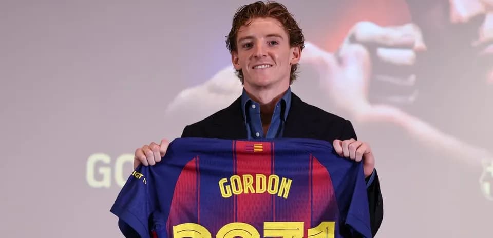 Player holding FC Barcelona jersey at presentation event