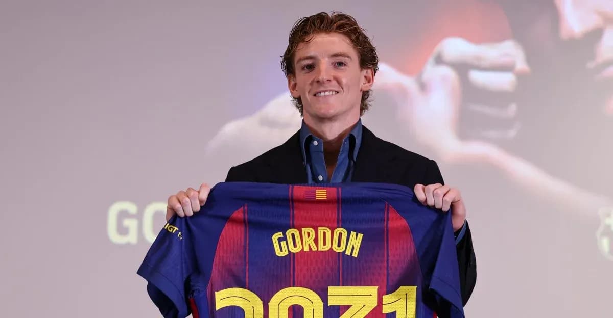 Player holding FC Barcelona jersey at presentation event