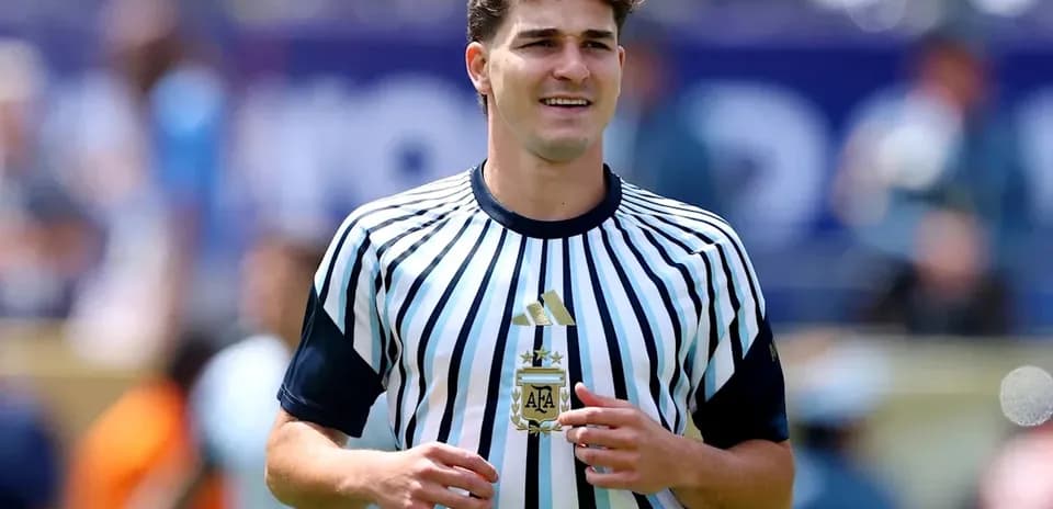 Player wearing striped Argentine jersey on field