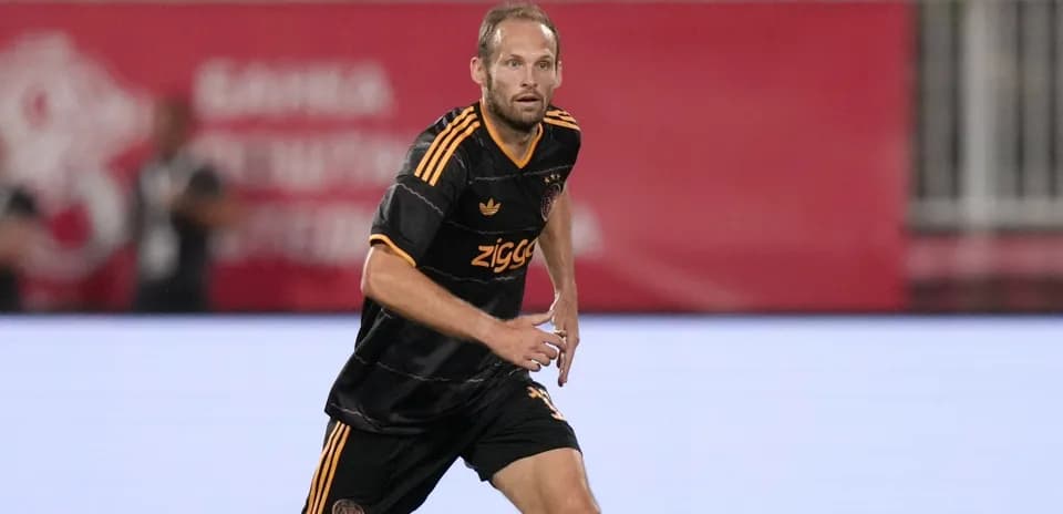 Player in black jersey running on the field