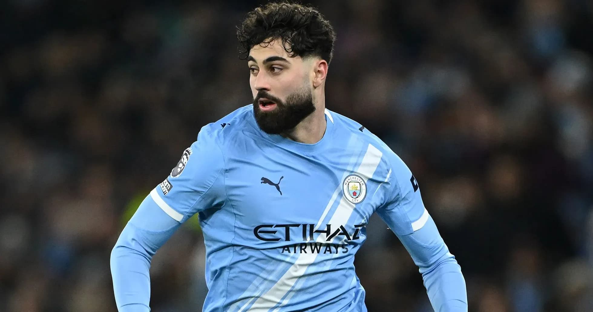 Player in light blue Manchester City jersey during match