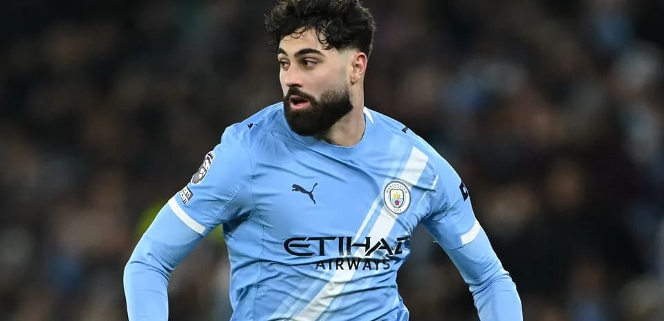 Player in light blue Manchester City jersey during match
