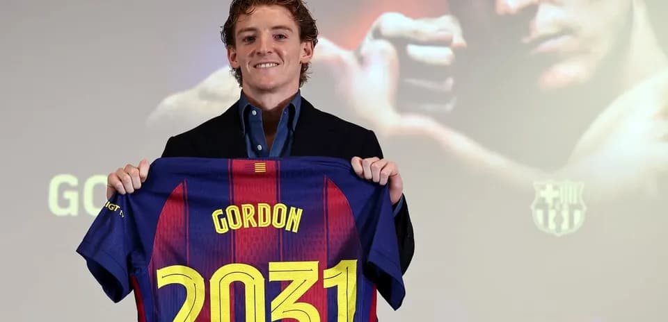 Player holding FC Barcelona jersey with name and number