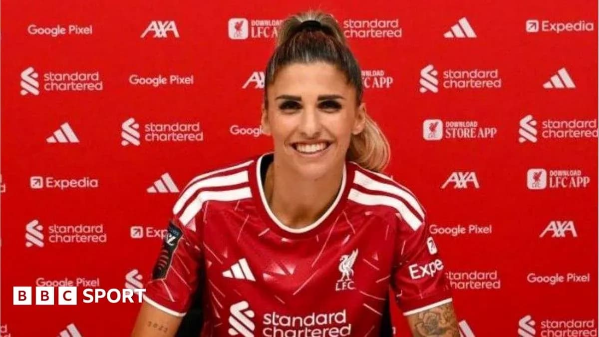 Player in Liverpool jersey at press conference