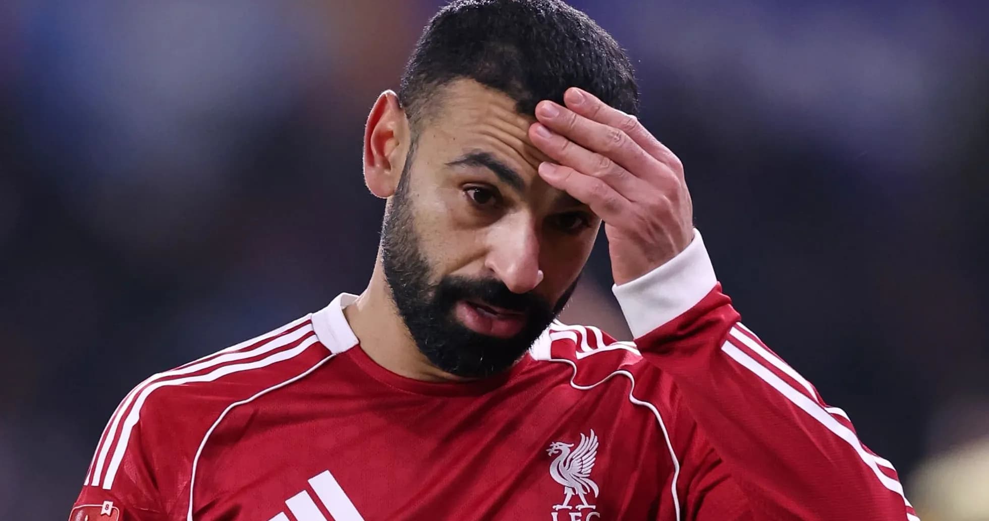 Player with hand on forehead during match