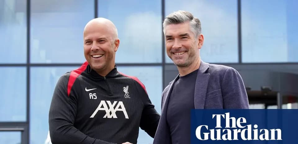Two coaches shaking hands outside training facility