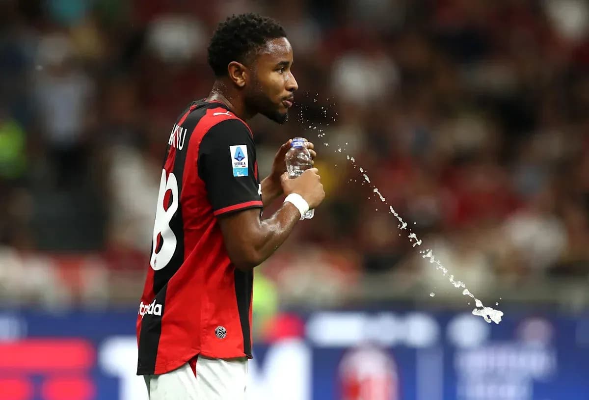 Player spraying water from bottle during match